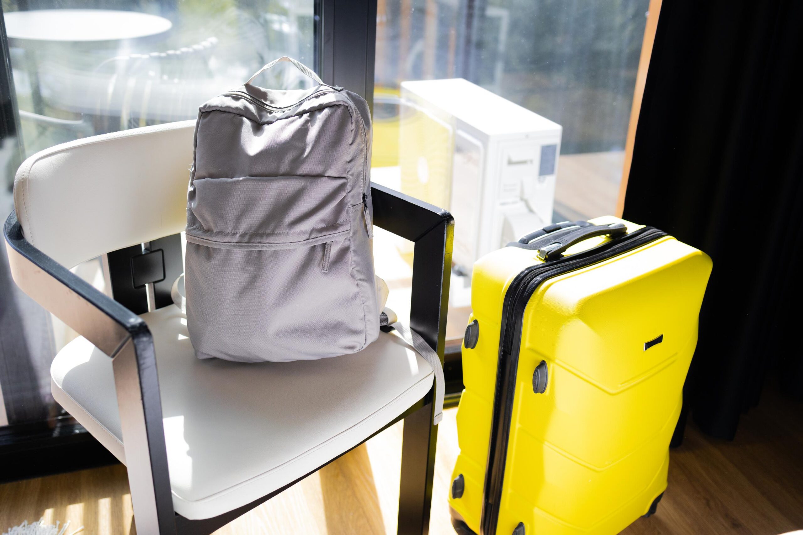 Backpack and yellow suitcase packed and ready for travel