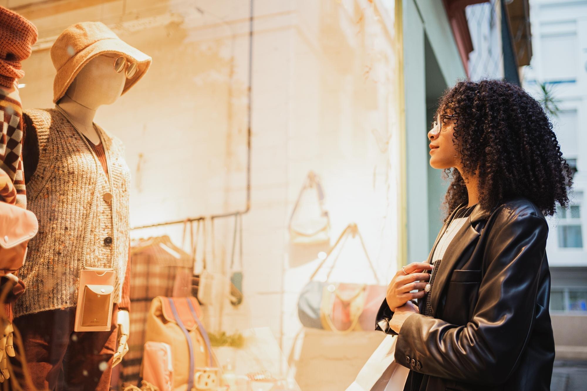 Shopper browsing a store window for brand-name deals